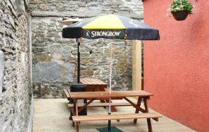 a picnic table with an umbrella on top of it at Holborn Hotel in Thurso