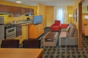 a large living room with a couch and a kitchen at Residences at Tewksbury in Tewksbury