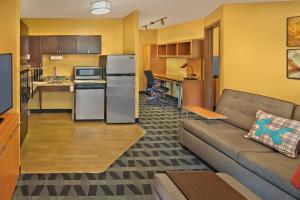 a living room with a couch and a kitchen at Residences at Tewksbury in Tewksbury