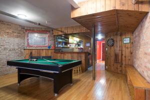 a room with a pool table and a bar at Wrigley Hostel - Chicago in Chicago
