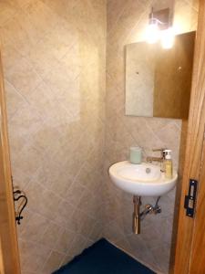 a bathroom with a sink and a mirror at Casa da Eira Velha in Vale de Cambra +32 photos