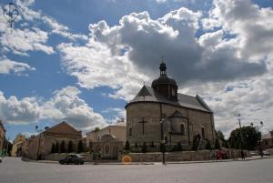 a large brick church with a cross on top of it at Apartment on Zarvanskaya in Old Town in Kamianets-Podilskyi