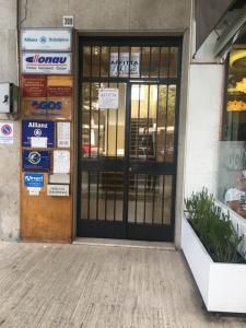 an entrance to a building with a revolving door at Luxurious Street Apartments in Catania