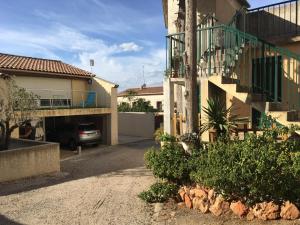 a car parked in a parking lot next to a building at Les couleurs de Balaruc Les Bains in Balaruc-les-Bains