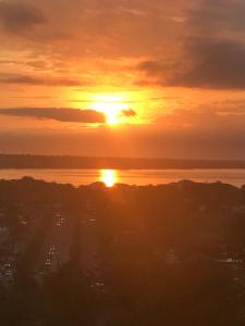 a sunset over the water with the sun in the sky at Quinta del Encanto in Cruz de Huanacaxtle