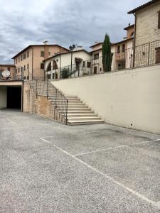 a parking lot with stairs in front of a building at Residence IL PODERE in Piobbico