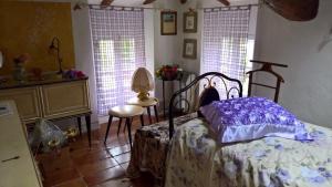 a bedroom with a bed in a room with windows at La Quercia - la maison des arts in Vezzano sul Crostolo