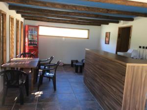 a dining room with a table and chairs at Cottages by the river in Rivadavia