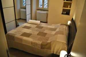 a bedroom with a bed with a quilt on it at Appartamento i Fabbri in Pistoia