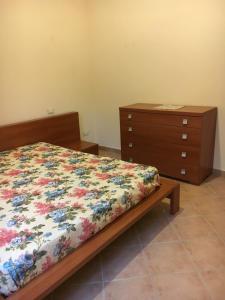 a bedroom with a bed and a dresser at Residence IL PODERE in Piobbico +27 photos