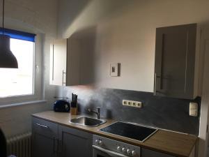 a kitchen with a sink and a counter top at NORDERTOR Refugium in Husum