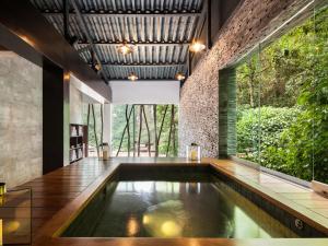 an indoor pool in the middle of a house at El MaPi by Inkaterra in Machu Picchu