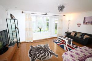 a living room with a zebra rug and a couch at Abbey Private House with Lovely Garden in London