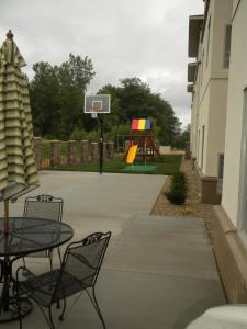 a patio with two chairs and a basketball hoop at GrandStay Residential Suites Hotel Faribault in Faribault