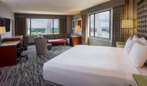 a hotel room with a large bed and a desk at Hyatt Regency Saint Louis at The Arch in Saint Louis +64 photos