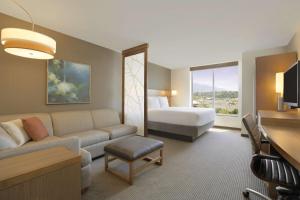 a hotel room with a couch and a bed at Hyatt Place Salt Lake City/Cottonwood in Cottonwood Heights