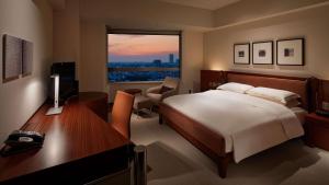 a hotel room with a large bed and a television at Grand Hyatt Tokyo in Tokyo
