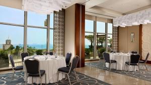 a conference room with tables and chairs and windows at Hyatt Regency Istanbul Atakoy in Istanbul