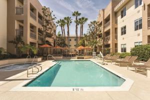 an image of a swimming pool at a apartment complex at Hyatt House Cypress / Anaheim in Cypress