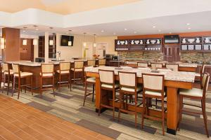 a large kitchen with a large bar with stools at Hyatt House Mount Laurel in Mount Laurel