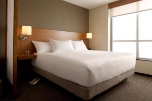 a large white bed in a hotel room with a window at Hyatt Place Atlanta Downtown in Atlanta