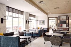 a lobby with couches and tables and chairs at Hyatt Place Madison/Verona in Verona