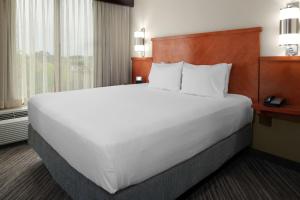 a large white bed in a hotel room at Candlewood Suites - Cincinnati Northeast - Mason, an IHG Hotel in Mason