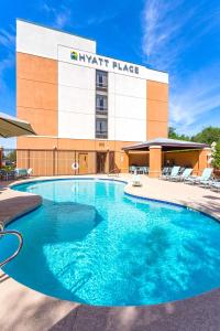 a swimming pool in front of a hyatt place hotel at Hyatt Place Phoenix-North in Phoenix