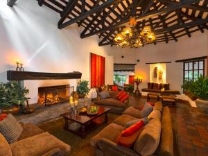 a large living room with couches and a fireplace at Inkaterra Machu Picchu Pueblo Hotel in Machu Picchu