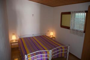 Appartamenti Posta del Sole tesisinde bir odada yatak veya yataklar
