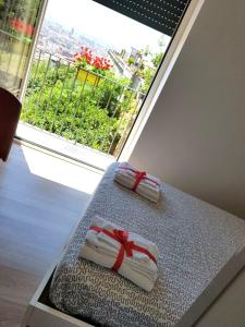 two towels with a red ribbon are sitting on a bed at B&B La Veduta in Naples +154 photos