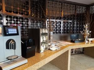 a wine shop with a counter with a drink dispenser at Grand Millennium Beijing in Beijing