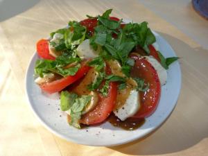 a plate of food with a salad on a table at Hotel Villa im Steinbusch in Malente