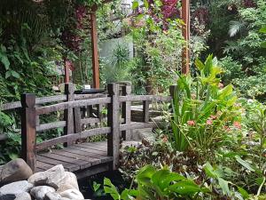a wooden bridge in the middle of a garden at Hotel Middle Path & Spa in Pokhara