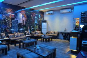 a bar with couches and tables and a wall with a city at Castle Peak Hotel in Cebu City