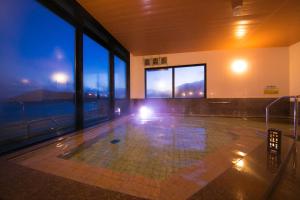 a empty room with a view of a pool at Ofunato Onsen in Ōfunato