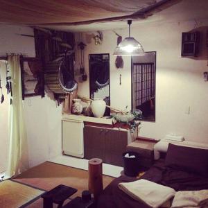 a living room with a table and a kitchen with at ILA Hakushu Guesthouse in Hokuto