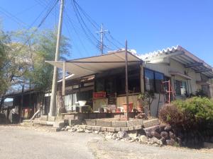 a building with a store front with a porch at ILA Hakushu Guesthouse in Hokuto