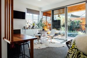 a living room with a table and chairs and a kitchen at BULC Boutique Bed & Breakfast in Belmont