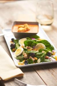 a plate of food with a salad on a table at Hyatt Place Austin Airport in Austin