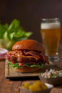 a sandwich on a table with a glass of beer at Hyatt Place Austin Airport in Austin