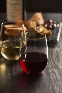 two glasses of wine sitting on a table at Hyatt Place Austin Airport in Austin