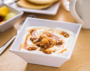 a white bowl of food with nuts on a table at Hyatt Place Austin Airport in Austin