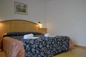 Postel nebo postele na pokoji v ubytování Hotel Corona