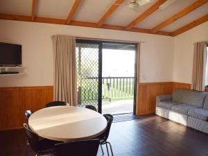 a living room with a table and a couch at Cohuna Waterfront Holiday Park in Cohuna