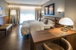 a hotel room with a bed and a desk at Central Plaza in Zürich