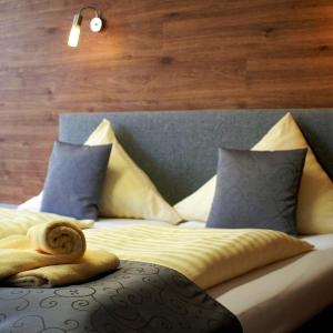 a bedroom with a bed with pillows and arolledigunigunigun at CREO Munich City in Munich