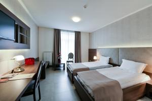 Postel nebo postele na pokoji v ubytování Hotel Majdan