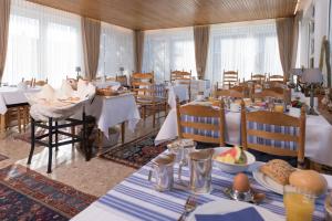 ein Esszimmer mit Tischen und Stühlen, auf denen Essen steht in der Unterkunft Atlantic Hotel Garni in Wangerooge + 37 Fotos