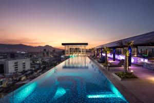 una piscina en la azotea de un edificio con vistas en Mercure Bandung City Centre en Bandung